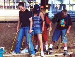Together, one of the CSI Youth Teams works to problem-solve a challenge on the CSI obstacle cours